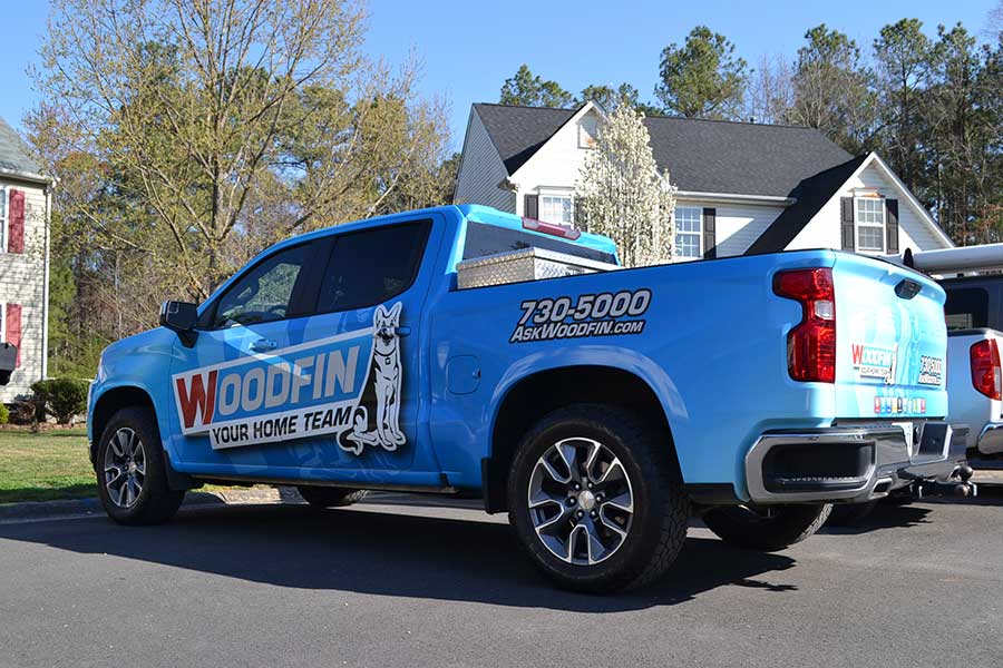 Woodfin Technician's truck in front of a residential property